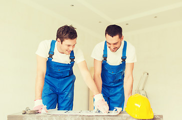 Image showing group of builders with blueprint