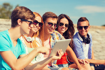 Image showing group of smiling friends with tablet pc outdoors