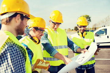 Image showing group of builders with tablet pc and blueprint