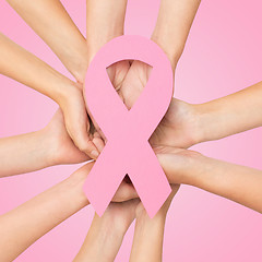 Image showing close up of hands with cancer awareness symbol