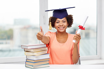 Image showing happy african bachelor girl with books and diploma