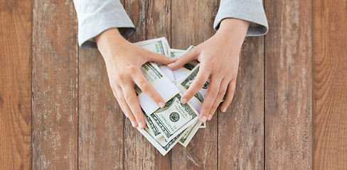 Image showing close up of woman hands counting us dollar money