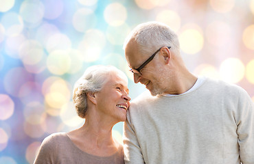 Image showing happy senior couple over holidays lights