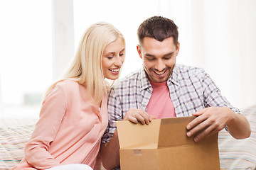 Image showing happy couple with parcel box at home