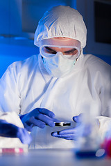 Image showing close up of male scientist with test sample in lab