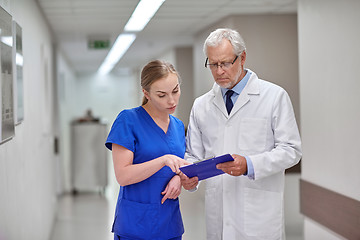 Image showing senior doctor and nurse with tablet pc at hospital