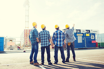 Image showing group of builders in hardhats outdoors