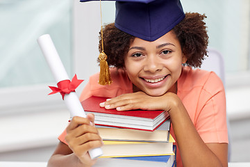 Image showing happy african bachelor girl with books and diploma