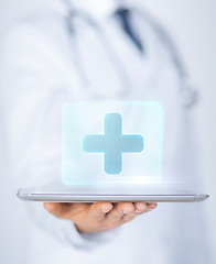 Image showing male doctor holding tablet pc with medical app