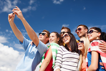 Image showing group of friends taking selfie with cell phone