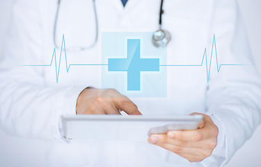 Image showing male doctor holding tablet pc with medical app