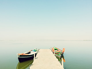 Image showing Calm lake with two fishing boats