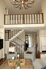 Image showing Elegant roomy living room with staircase.