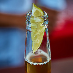 Image showing ice cold beer in a bottle with wedge lime