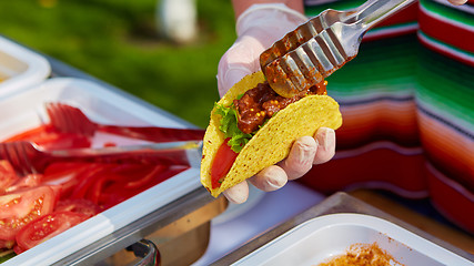 Image showing Chef making tacos at a street cafe