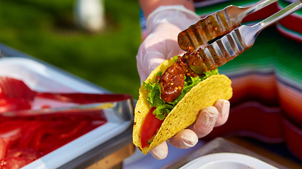 Image showing Chef making tacos at a street cafe