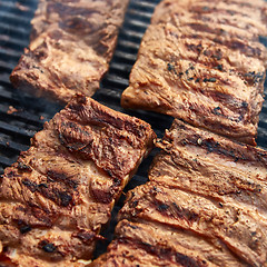 Image showing Grilled pork ribs on the grill.