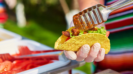 Image showing Chef making tacos at a street cafe