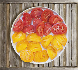 Image showing Cuted red and yellow tomatoes in a plate