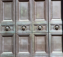 Image showing in london antique brown door  rusty  brass nail and light