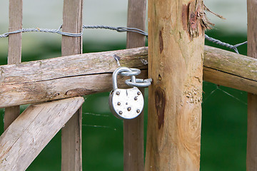 Image showing Locked wooden fence