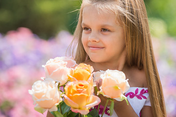 Image showing Girl princess in a beautiful dress holding a bouquet of roses