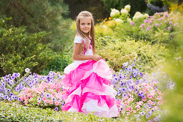 Image showing Girl Princess in the garden flower bed