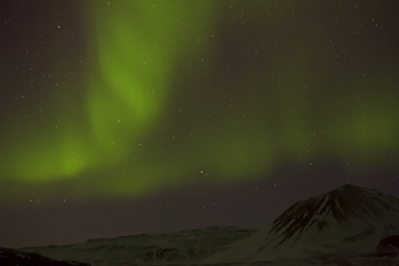 Image showing Northern lights with snowy mountains in the foreground