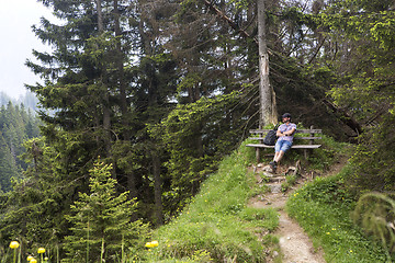Image showing Hiker takes a break and enjoys the view