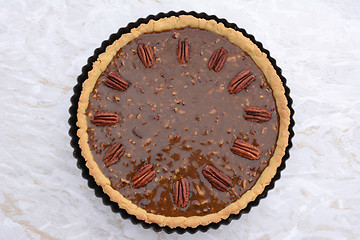 Image showing Pecan pie decorated with nuts ready to be baked