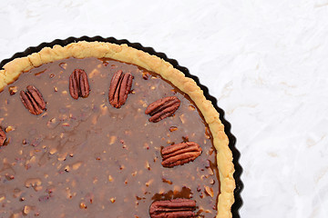 Image showing Pecan nuts decorating the top of an unbaked pecan pie