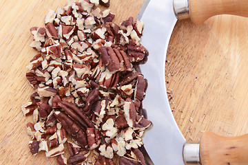 Image showing Chopped toasted pecans with a rocking knife