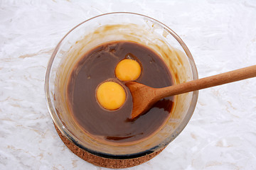 Image showing Stirring egg yolks into pecan pie filling