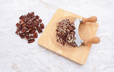 Image showing Toasted pecans with a rocking knife 