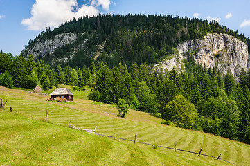 Image showing Single house on a meadow in mountains