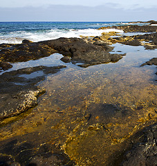 Image showing beach  light  water   lanzarote foam rock spain    stone sky clo