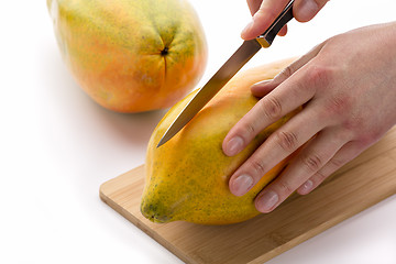 Image showing Knife Positioned For A First Cut Through A Papaya