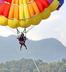 Image showing Parasailing in a blue sky near sea beach