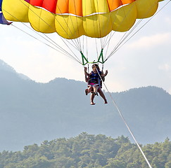 Image showing Parasailing in a blue sky near sea beach