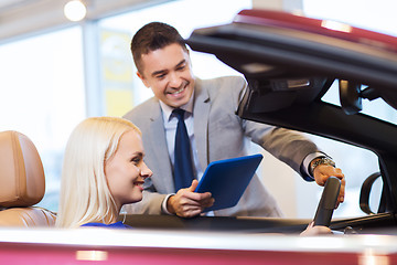 Image showing happy woman with car dealer in auto show or salon