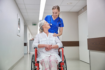 Image showing nurse with senior woman in wheelchair at hospital