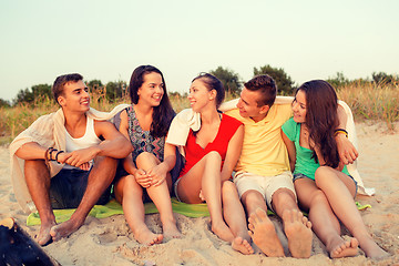 Image showing smiling friends in sunglasses on summer beach