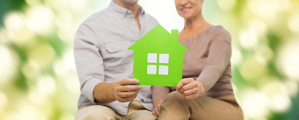 Image showing close up of happy senior couple with green house