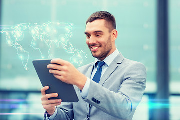 Image showing smiling businessman with tablet pc outdoors