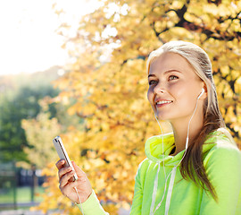 Image showing woman listening to music outdoors