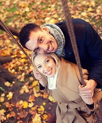 Image showing smiling couple hugging in autumn park