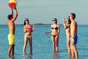 Image showing smiling friends in sunglasses on summer beach