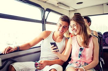 Image showing smiling couple with smartphone making selfie