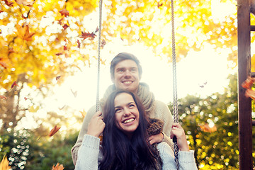 Image showing smiling couple hugging in autumn park