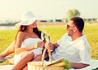 Image showing smiling couple drinking champagne on picnic